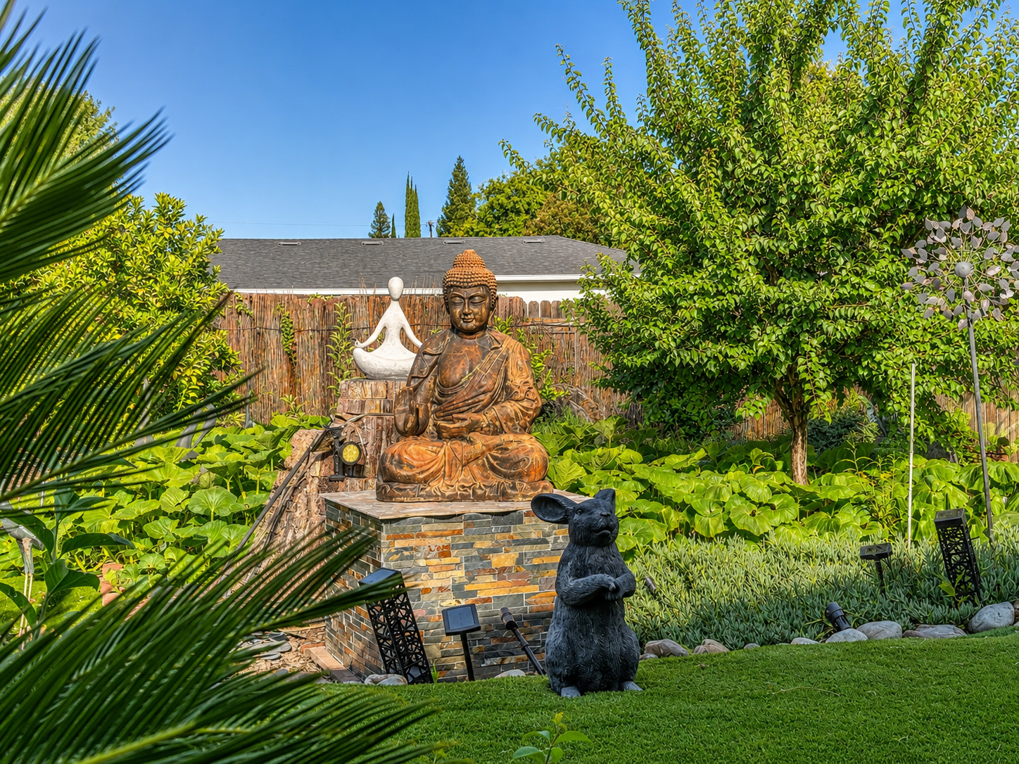Peaceful zen garden with Buddha and meditation statues at The Oaks at Garfield memory care Carmichael CA