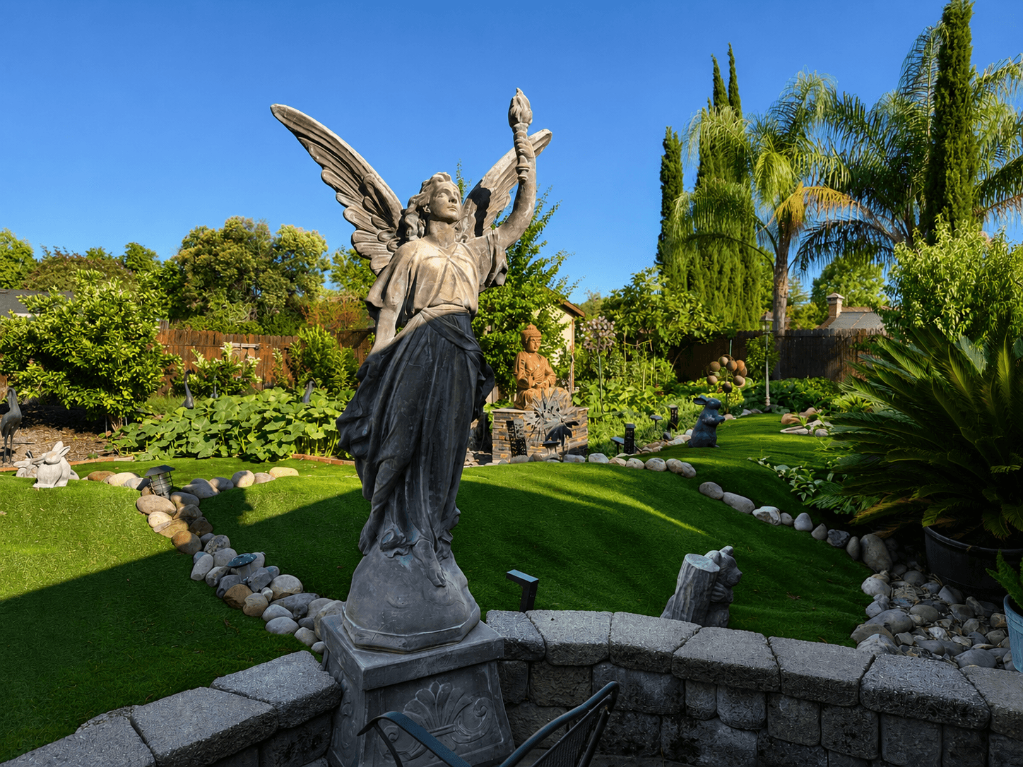 Peaceful garden with angel statue at The Oaks at Garfield hospice support care Carmichael CA